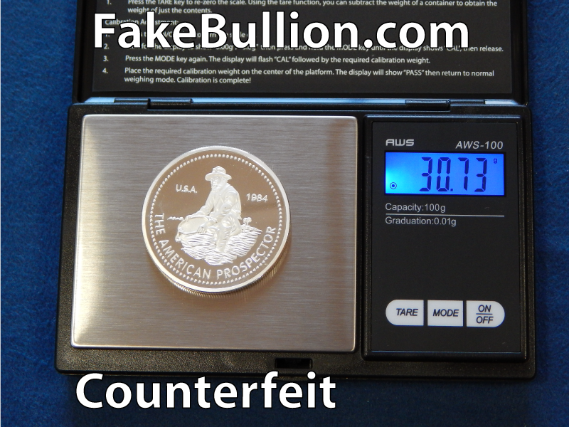 weighing counterfeit silver round